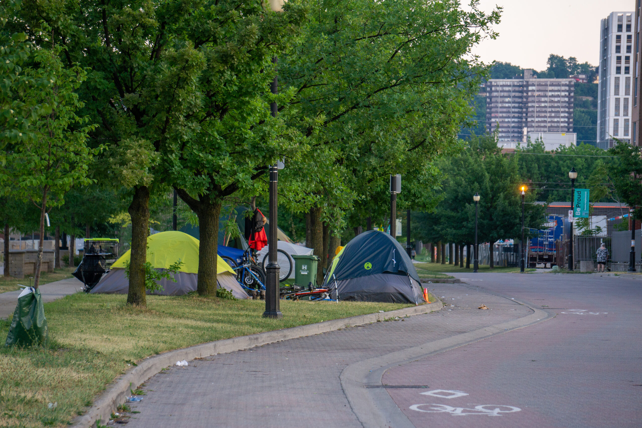photos shows a group of tents alongside a roadway